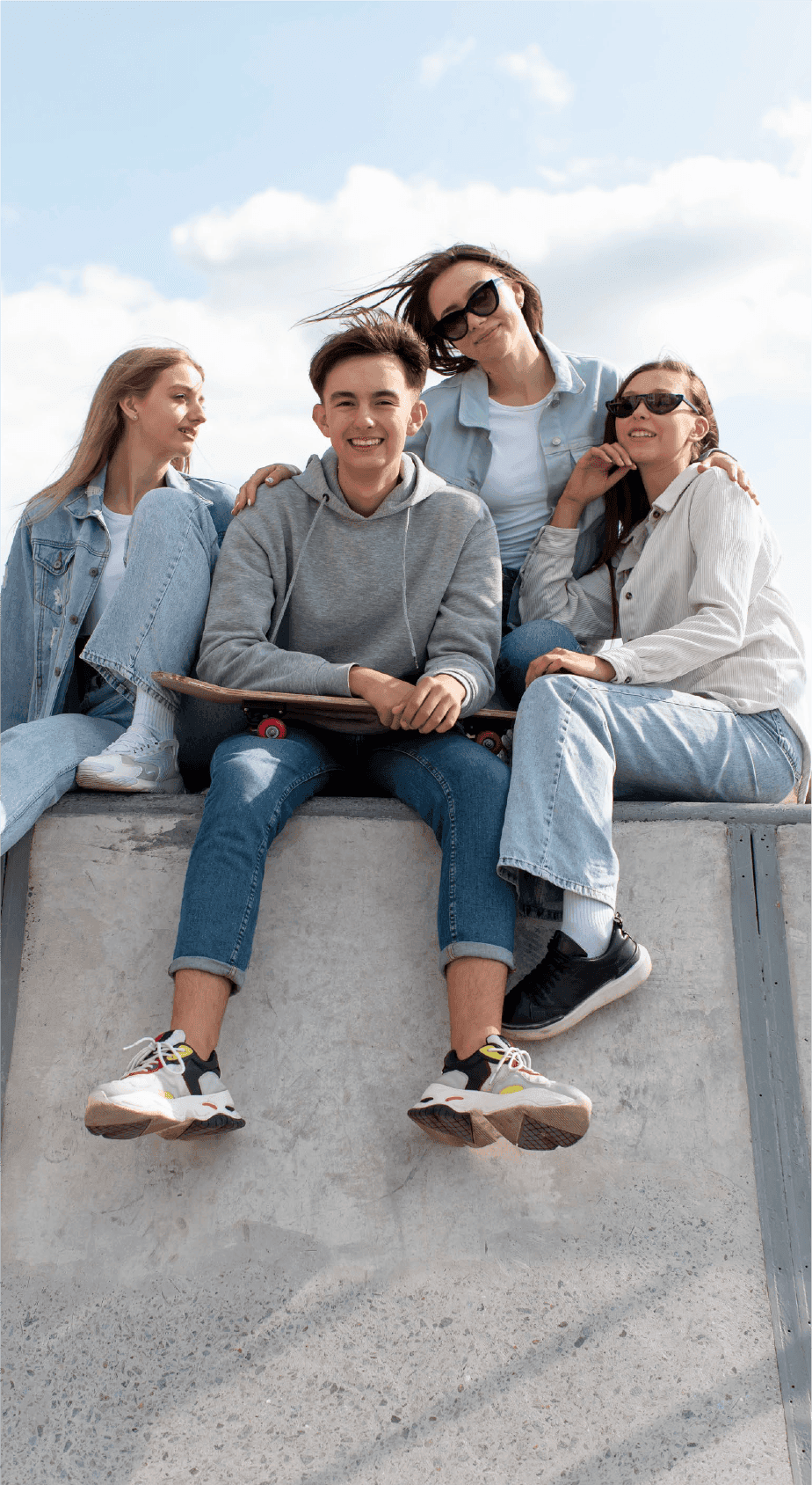 Group of young friends sitting on a skate ramp
